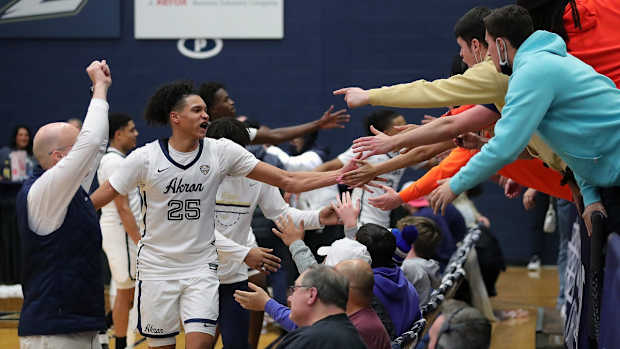 Akron Zips forward Enrique Freeman (25) celebrates with the Ak-Rowdies after beating the Eastern Michigan Eagles,46-44, in an NCAA basketball game, Saturday, Jan. 22, 2022, in Akron, Ohio.

Zipsmbb 1